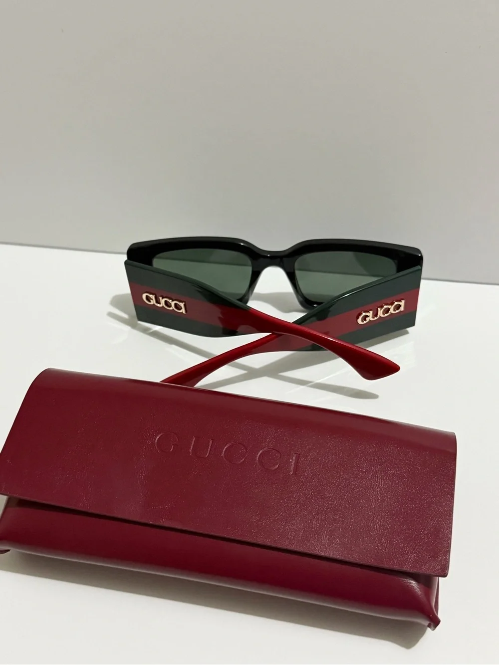Gucci Black Frame Sunglasses with Red Temples and Gold Logo